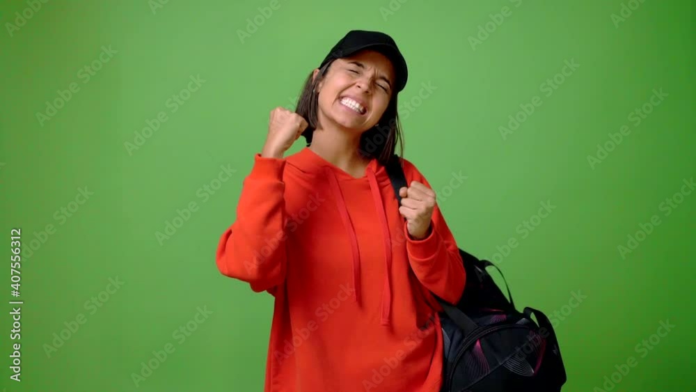 Woman with sport bag celebrating a victory and surprised to be successful Woman with sport bag celebrating a victory and surprised to be successful