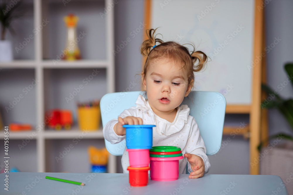 little happy toddler girl playing at the table little happy toddler girl playing at the table