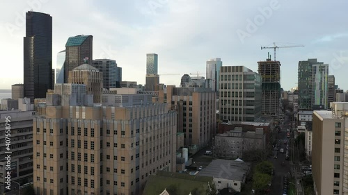 Cinematic aerial drone rise and reverse reveal footage of Harborview Medical Center, First Hill, Yesler Terrace, Atlantic, Cherry Hill, Squire Park, skyscrapers, downtown Seattle, Washington photo