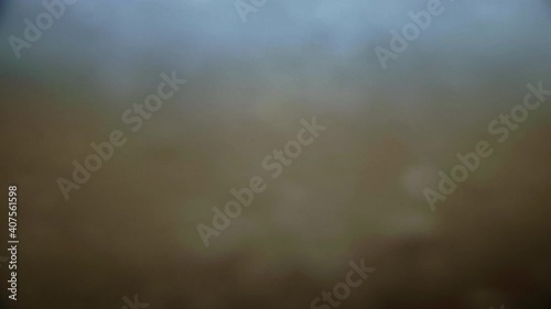 Ocean waves washing over beach sand and into camera lens, Slow Motion