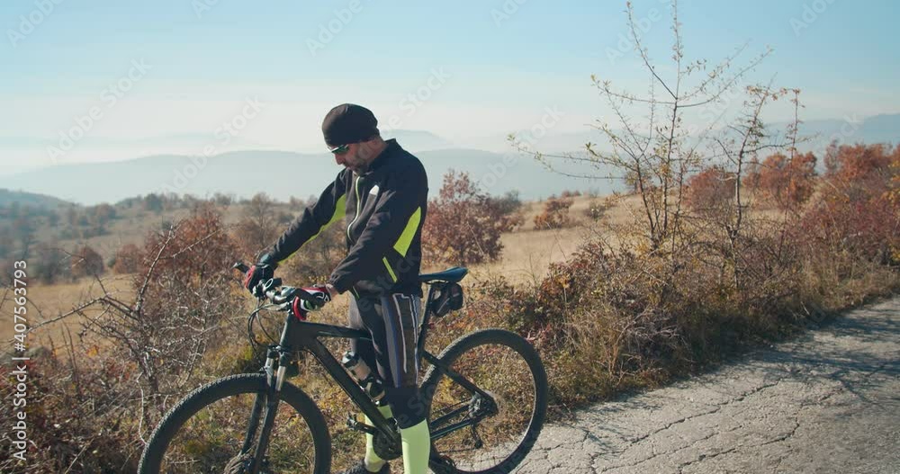 Adult male riding his bicycle in the countryside Adult male riding his bicycle in the countryside