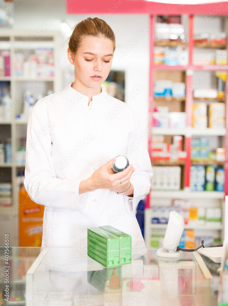 Female pharmacist offering help in choosing at counter in pharmacy. High quality photo