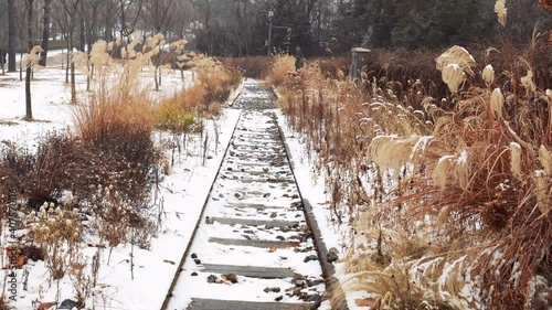 Snow fell on rusty railroad tracks in Seoul Children's Grand Park, South Korea