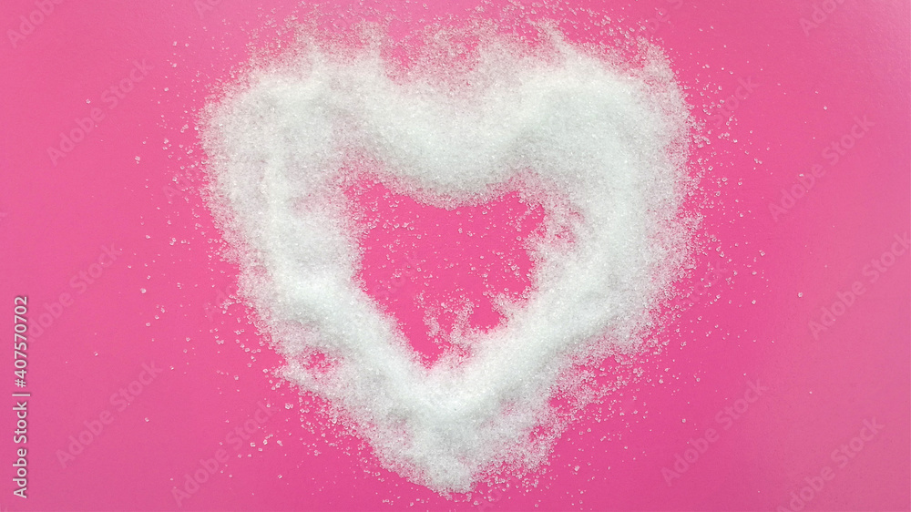The sugar sprinkled on a pink heart shaped background.