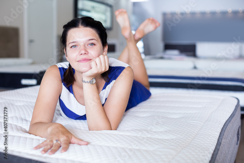 Young female lying on soft mattress and smiling in store Free Download Young female lying on soft mattress and smiling in store - GFXLoad