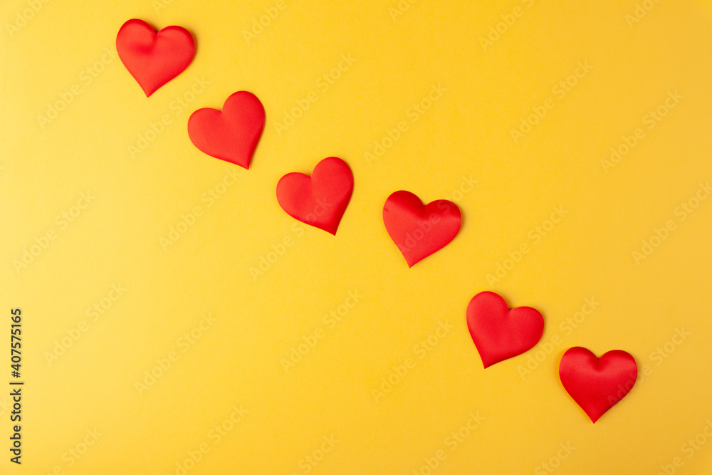 Red hearts on colored yellow background, valentine's day greeting card
