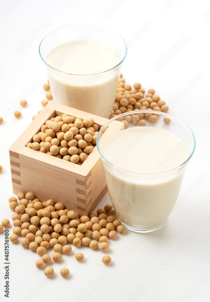 Soy milk and soybeans in a glass on a white background Soy milk and soybeans in a glass on a white background