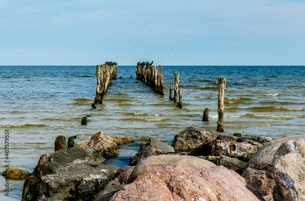 Abandoned old broken pier at Baltic Sea, autumn storm with drops of rain, concept of weather forecast Abandoned old broken pier at Baltic Sea, autumn storm with drops of rain, concept of weather forecast