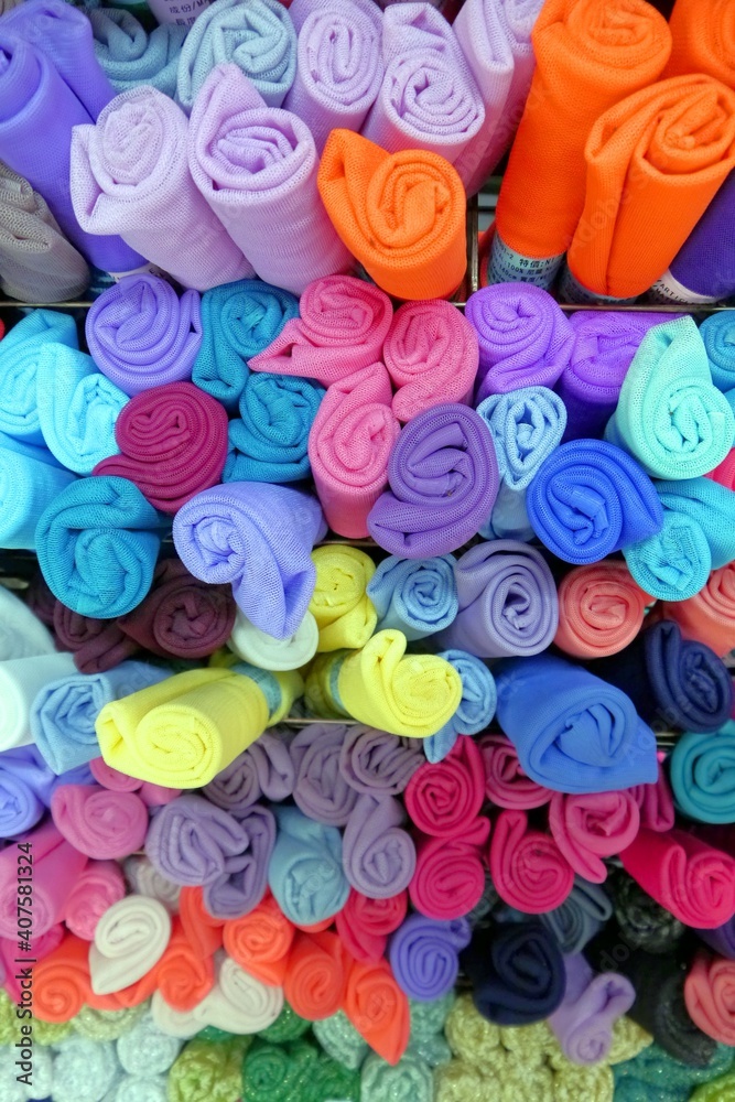 Colorful Polyester fabric. Rolls of cloth background.