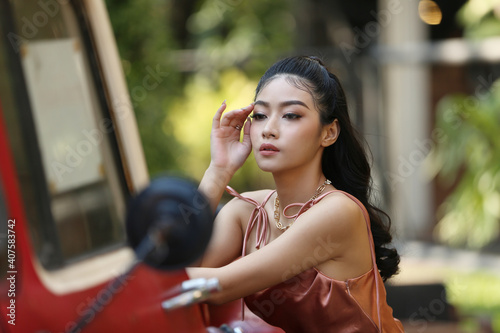 elegant sensual young woman in brown dress on recamier outdoor shot photo