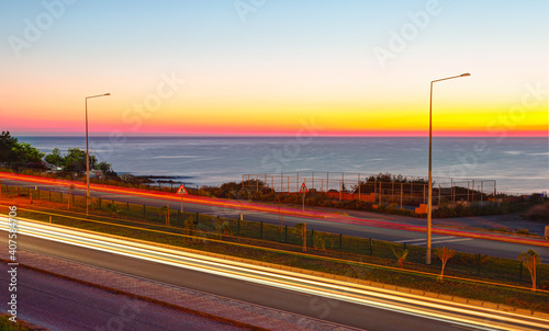 Traffic light trails on highway at dusk 