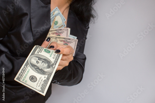 Obraz na plátně Female hands hold dollar bills.