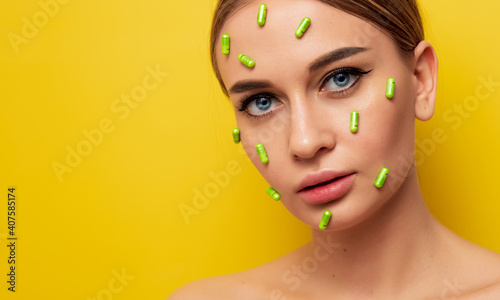 Portrait of a woman, cosmetology, beauty pills, fashion, skin care. On a yellow background