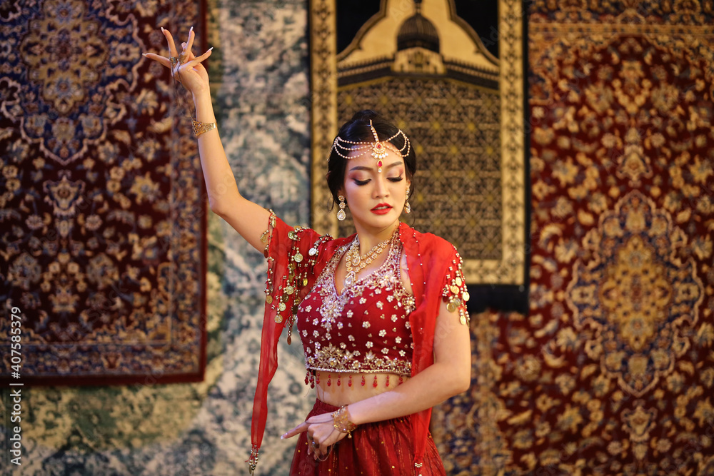 Portrait of beautiful indian girl . Young hindu woman model in sari and kundan jewelry . Traditional India costume lehenga choli . Eastern or Arabic culture.