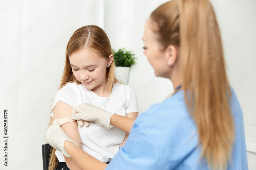 female doctor next to girl vaccination health treatment female doctor next to girl vaccination health treatment