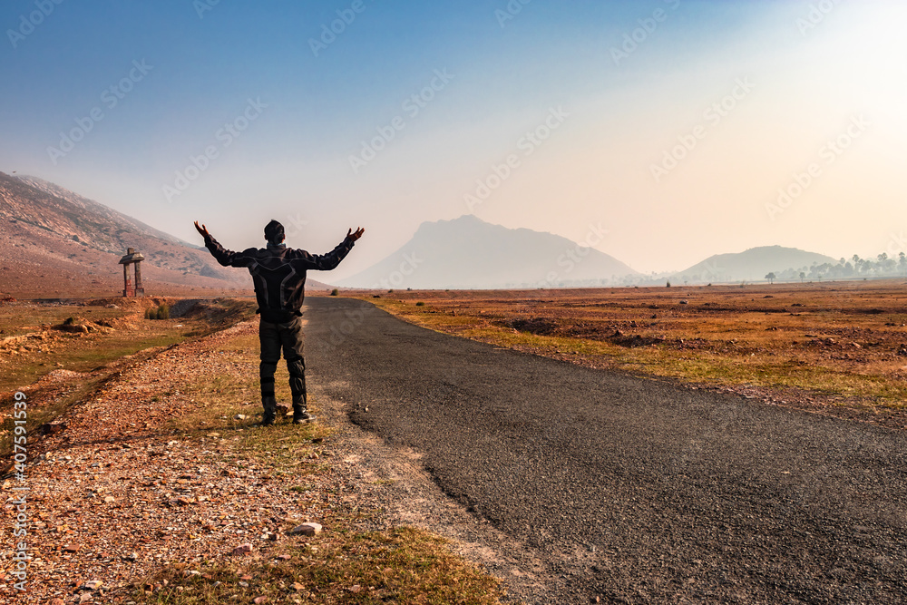 Obraz premium motorcycle rider standing on tarmac road isolated