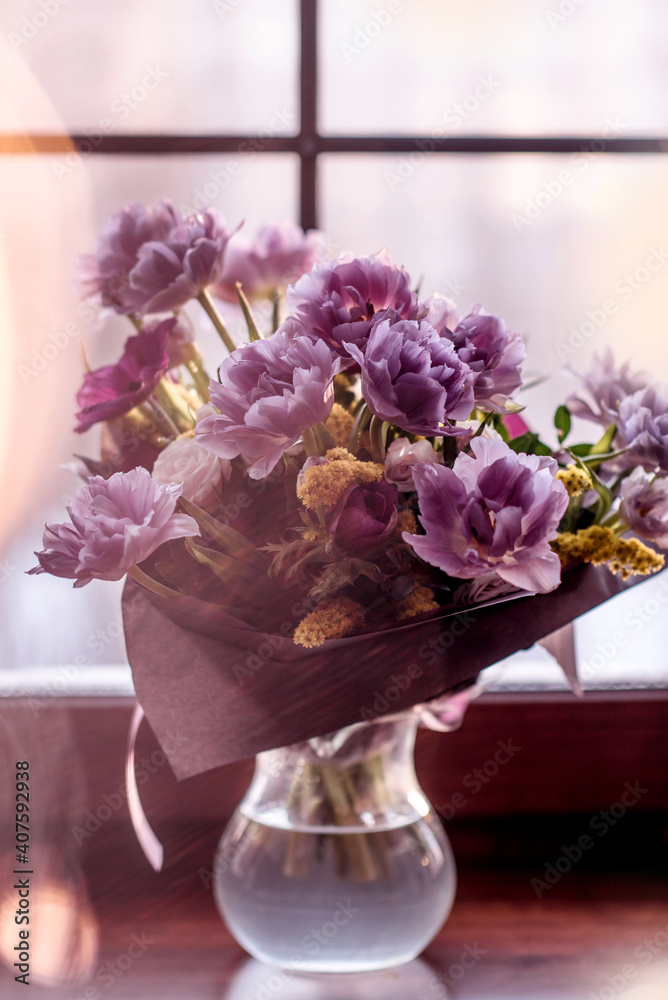 a rare variety of tulip. bouquet of double purple tulips. bouquet with Christmas lights a rare variety of tulip. bouquet of double purple tulips. bouquet with Christmas lights