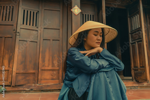 Beautiful Vietnam girl from Hue city, Vietnam who wearing Ao dai. Ao dai is famous traditional custume for woman in Vietnam. Vintage style,travel and relaxing concept.