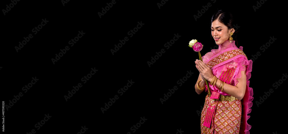 Loykratong tradition,Beautiful women dressed in Thai national costumes. hold kratong isolated on black background, Studio shot Loykratong tradition,Beautiful women dressed in Thai national costumes. hold kratong isolated on black background, Studio shot
