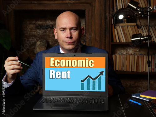 Financial concept about Economic Rent with sign on laptop in hand.
