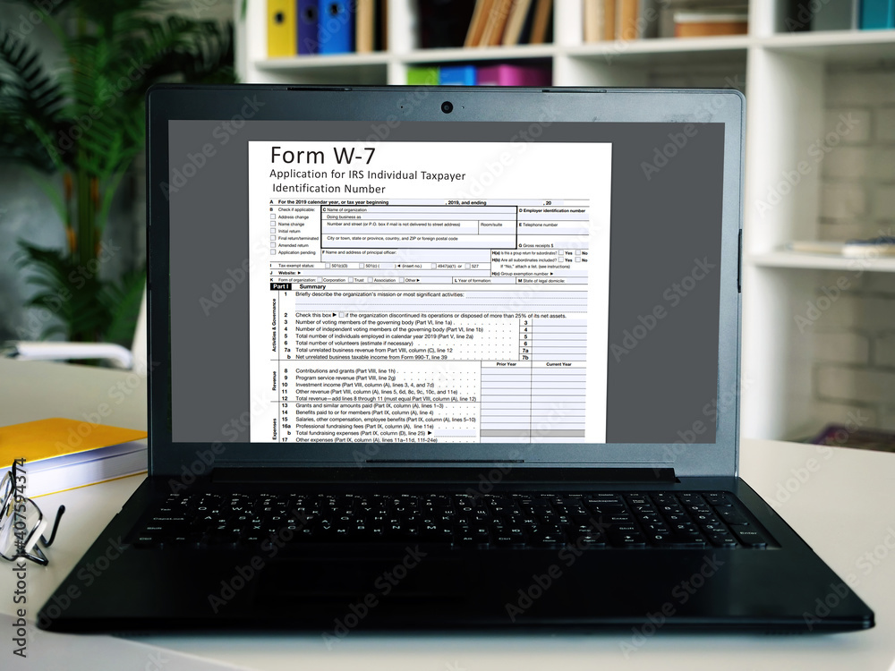 Fototapeta premium Business concept meaning Form W-7 Application for IRS Individual Taxpayer Identification Number with inscription on the sheet.