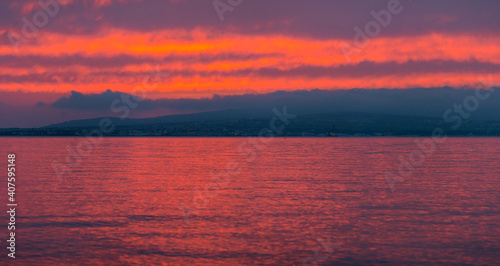 Seascape. Sun in the clouds at sunset over the sea