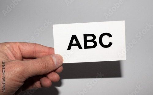 Message on the card ABC in hands of businessman.