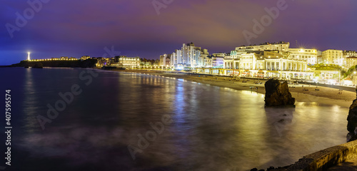 Seascape at night in Biarritz France in long photographic exposure. Beach and buildings at night in summer. 