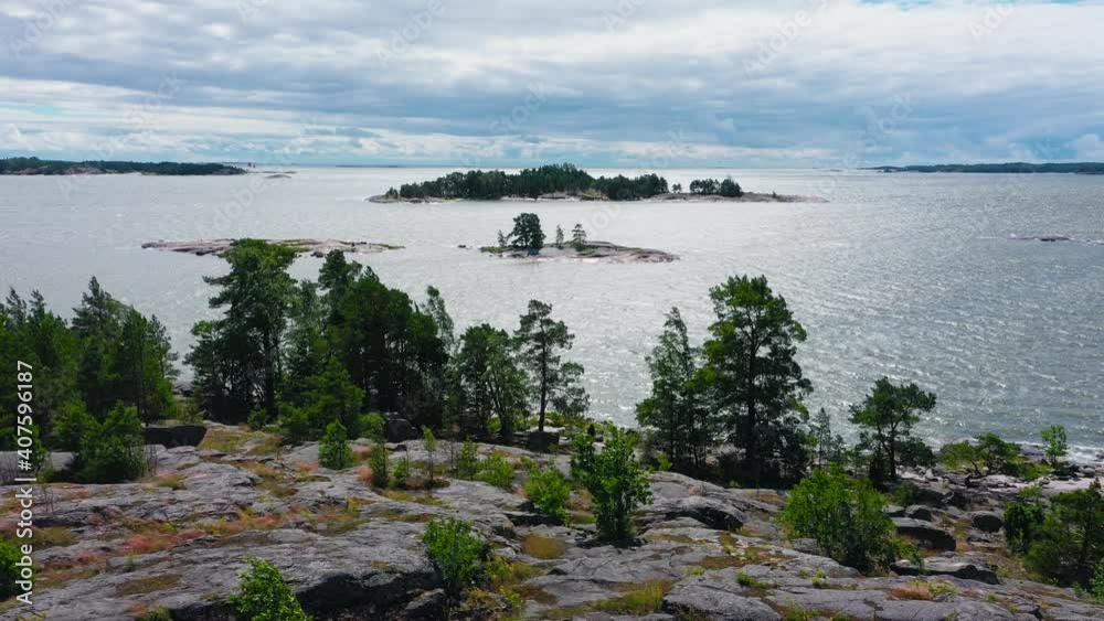 Aerial view of people on the coast of Finland, windy day - reverse, drone shot Aerial view of people on the coast of Finland, windy day - reverse, drone shot