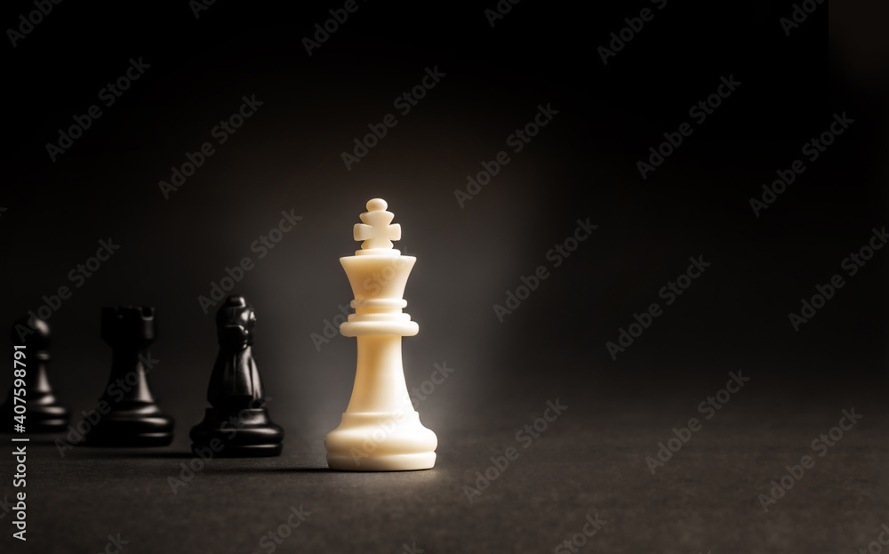 Leader can make an impact and different concept, White chess king standout from all the blurred black chess Leader can make an impact and different concept, White chess king standout from all the blurred black chess