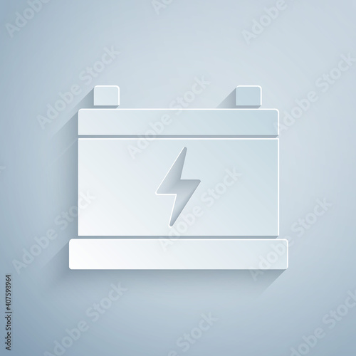 Paper cut Car battery icon isolated on grey background. Accumulator battery energy power and electricity accumulator battery. Paper art style. Vector.