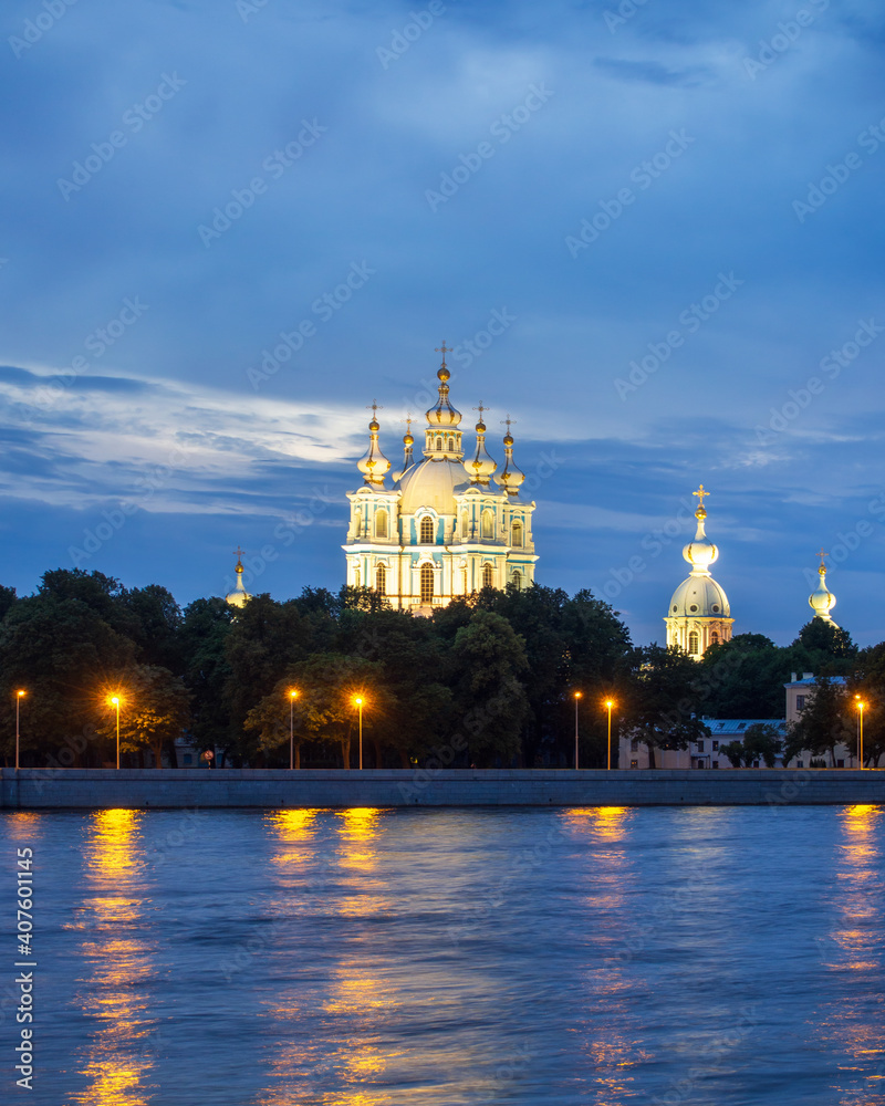 Naklejka premium Russia, St. Petersburg - July 19, 2020: View of the Smolny Cathedral from the Neva at night on a cloudy summer day. Russia, Saint-Petersburg