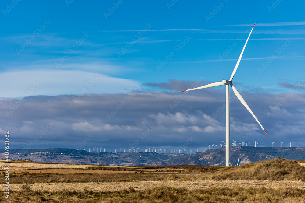 wind turbine in the foreground with many wind turbines on the horizon wind turbine in the foreground with many wind turbines on the horizon