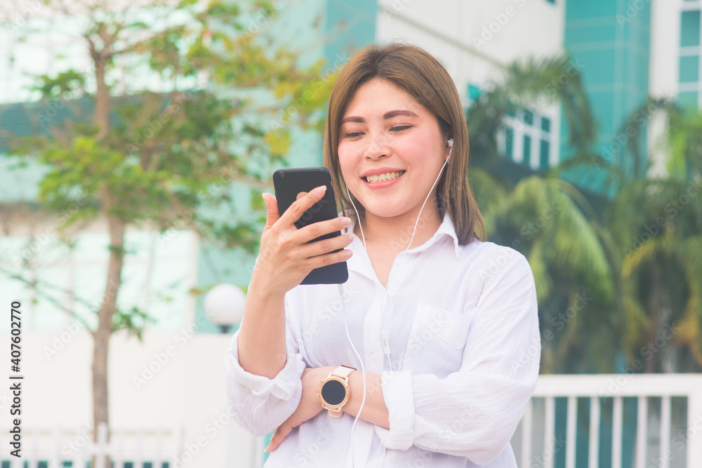Asian women use mobile smartphone to shopping online at home outdoor