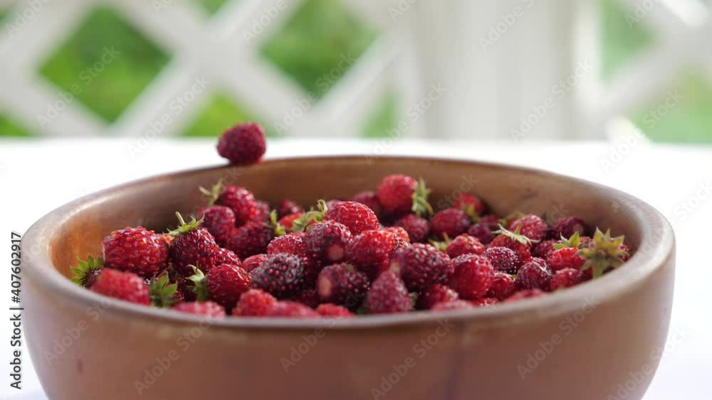Strawberry are hitting the wooden bowl in super slow motion Strawberry are hitting the wooden bowl in super slow motion