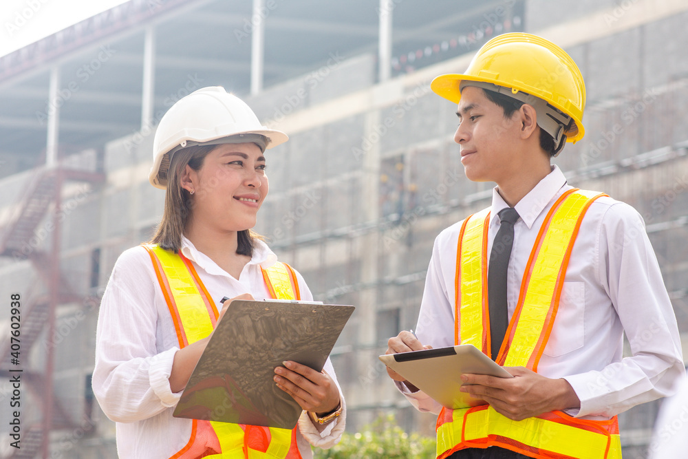 Two people Asian engineer use tablet talking check inspection plan in project civil property building construction, Man women work smart technology Two people Asian engineer use tablet talking check inspection plan in project civil property building construction, Man women work smart technology