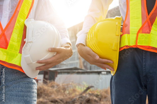 Close up businesspeople holding hard hat outdoor on site building construction