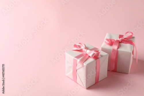 Gift boxes on pink background, space for text © Atlas