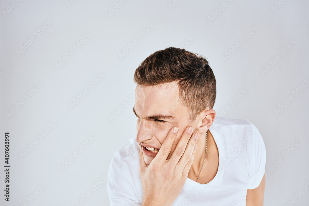 emotional man gesturing with his hands displeased facial expression white t-shirt cropped emotional man gesturing with his hands displeased facial expression white t-shirt cropped