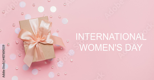 Gifts on pink background, love and valentine concept with text International Womens Day © Daria Lukoiko