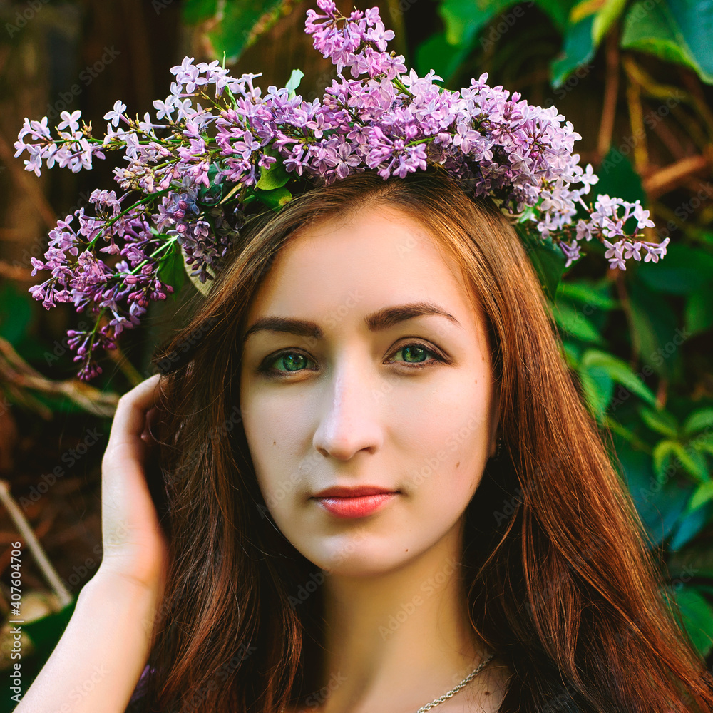 Portrait of young beautiful woman in pink dress in spring garden with lilacs. Spring background. Woman's Day. Greeting card. 