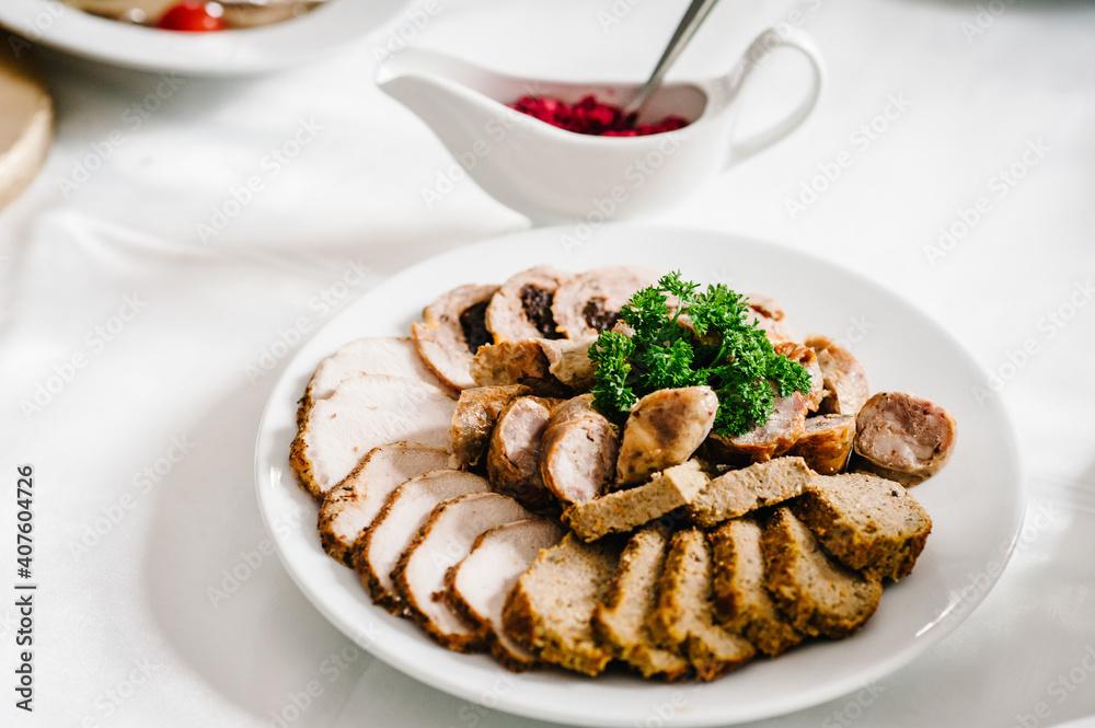 Meat slicing with delicious salami, pieces of sliced meat. Meat platter with selection. Cold smoked meat plate with bacon, pork chops. top view