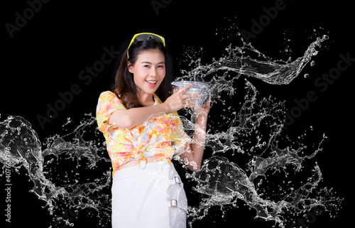 Thai girl smiling Asian beauty Swimming with ancient bowls Preserve the good culture of Thai people during Songkran festival. Thai New Year  Family Day in April