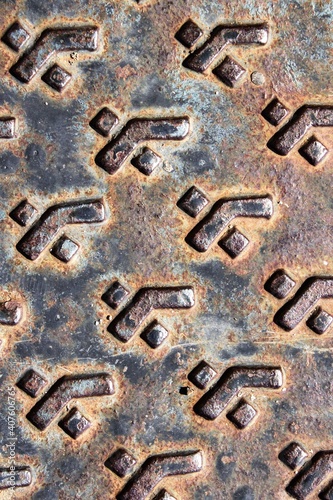 evocative image of texture of metal plate with embossed square patterns
