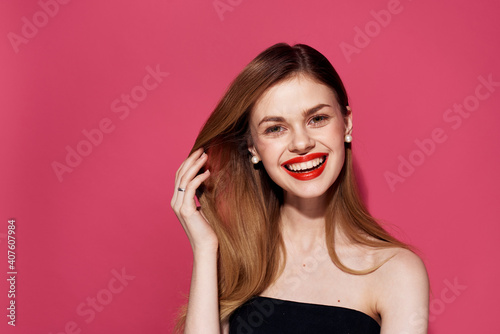 Cheerful woman cosmetics red lips smile attractive look pink background