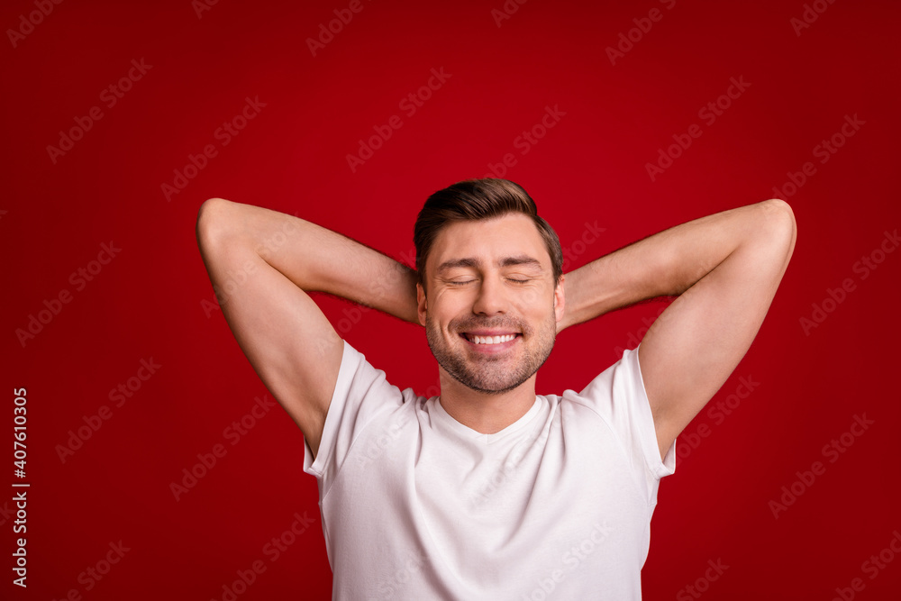 Portrait of satisfied person arms behind head closed eyes taking nap isolated on burgundy color background Portrait of satisfied person arms behind head closed eyes taking nap isolated on burgundy color background