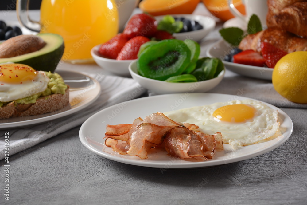 Healthy breakfast. Toast with avocado and egg, bacon and eggs, fresh and dried fruits, fresh juice Healthy breakfast. Toast with avocado and egg, bacon and eggs, fresh and dried fruits, fresh juice
