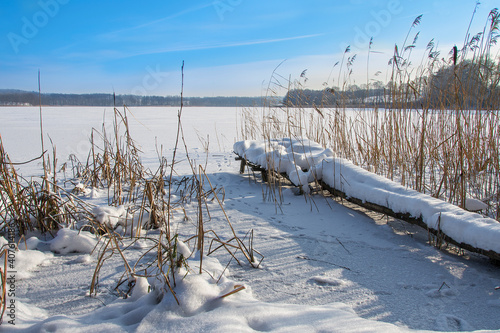 frozen lake and pier, beautiful winter landscape, Masuria in Poland