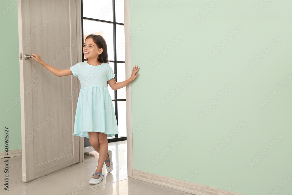 Cute little girl standing in doorway Stock Photo | Adobe Stock