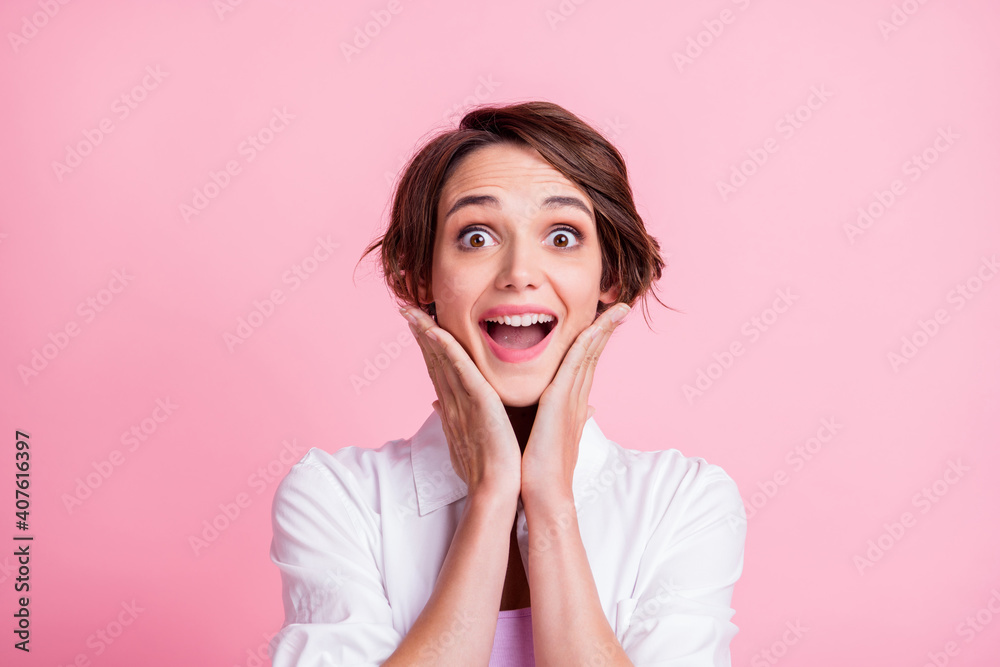 Photo portrait of amazed shocked happy girl touching cheeks opened mouth isolated on pink pastel color background Photo portrait of amazed shocked happy girl touching cheeks opened mouth isolated on pink pastel color background